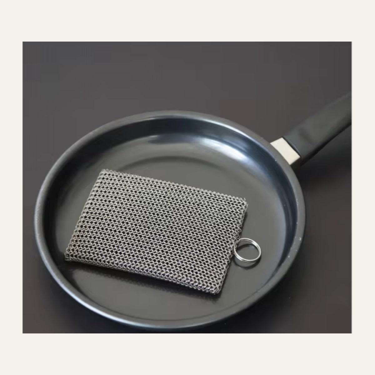 Welded G2 Iron Armor Set scrubber and stainless hanging ring resting in a cast iron skillet